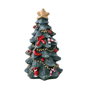 Miniature green resin Christmas tree desk ornament with star topper and red bows decoration