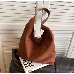 Brown faux suede hobo shoulder bag with a minimalist slouchy design on a white background