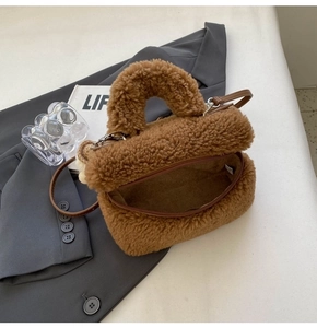Top view of brown plush bucket bag showing interior texture on grey fabric backdrop