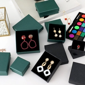 Macro shot of dark green and black jewelry boxes with soft sponge lining for earrings