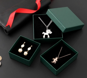 Deep green jewelry gift boxes set featuring silver and rose gold animal necklaces