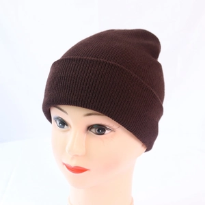 Close-up of soft ribbed knit texture on a dark brown winter beanie hat for adults