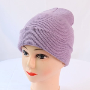 Detail view of purple ribbed knit beanie on a display head showing texture and warm material