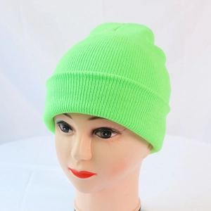 Detail view of a neon green ribbed knit beanie on a mannequin head for winter warmth
