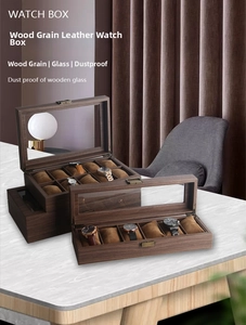 Macro detail of wooden grain leather watch box with glass lid and soft brown pillows