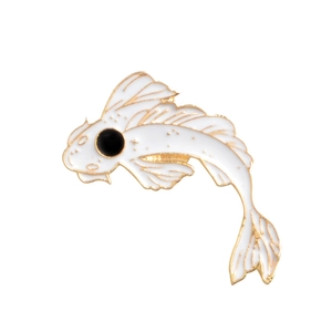 Close-up of white koi fish enamel brooch with gold edges and detailed metal plating