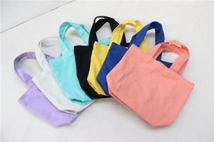 Selection of mini canvas handbags in seven vibrant colors displayed in a fan-shaped layout