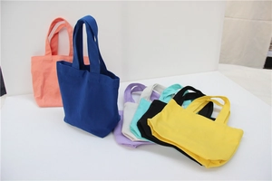 Detail of colorful canvas lunch bags showing smooth knit fabric and various vibrant colors