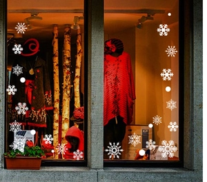 Detail view of white Christmas snowflake static window stickers applied on store glass