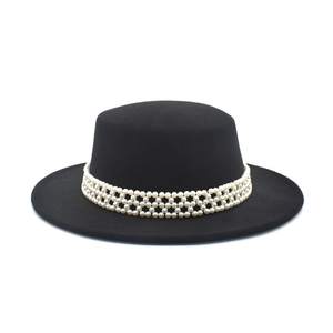 Detail of a black wool boater hat featuring a decorative four-layer pearl beaded band