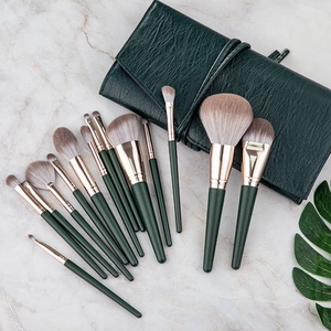 Detailed view of 14-piece green makeup brush set with elegant rose gold ferrules