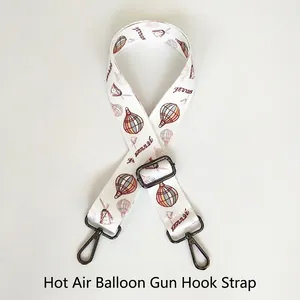 Detail of adjustable bag strap featuring colorful hot air balloon and windmill patterns