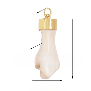 Detail view of a white ceramic fist charm with gold ring showing size and weight data