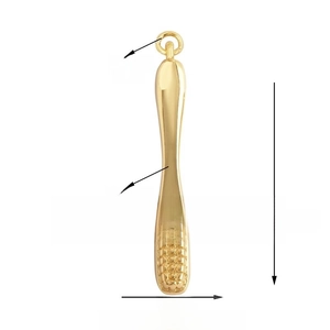 Detailed view of golden toothbrush pendant with 27mm length and textured bristles