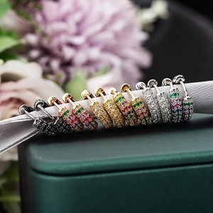 Rainbow CZ stone huggie earrings in gold, silver and rose gold displayed on green box