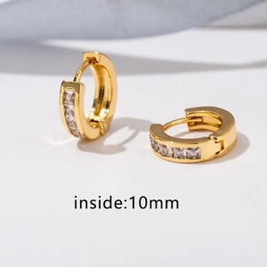 Macro detail of gold-plated huggie earrings featuring square-cut zircons and 10mm inner diameter