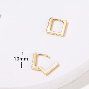 Detail shot of 10mm gold rectangular earrings with zircon inlay showing closed and open clasp