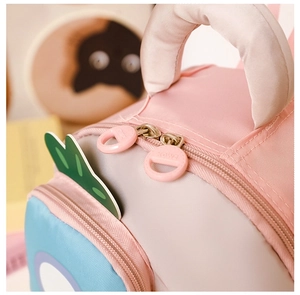 Detail view of the zipper and handle of a pink and blue stylish kids backpack