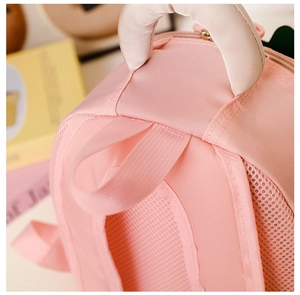 Detail of pink toddler backpack showing thickened padded handle and breathable mesh back