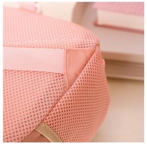 Detail of pink honeycomb mesh fabric with reinforced triangular stitching on straps