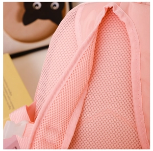 Close-up of pink kids backpack showing breathable honeycomb mesh back and thick straps