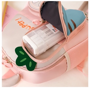 Close-up of pink toddler backpack front pocket holding a marker box for storage view