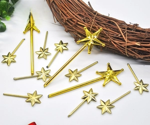 Close-up of golden star-shaped magic wands for Christmas DIY craft decorations