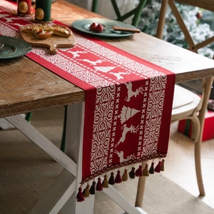 Christmas table runner with red reindeer and snowflake jacquard patterns and tassels