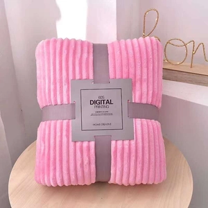 Detail of folded pink flannel blanket with vertical stripes and elegant ribbon packaging