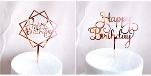 Detail of rose gold acrylic Happy Birthday cake toppers with mirrored finish
