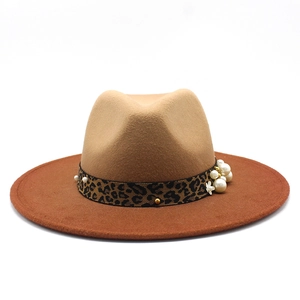 Detail of wool fedora with leopard band, pearls, gold studs and white flower accents