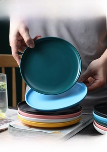 Detail view of colorful matte ceramic plates set in Nordic style for home dining