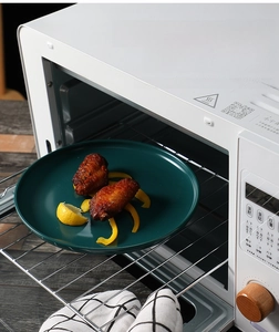 Deep green matte ceramic dinner plate used for baking chicken wings in an oven