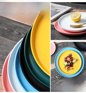 Detailed view of matte ceramic plates in vibrant colors showing stacking texture