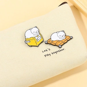 Cute enamel cat pins featuring cats on a toaster and cushion on a canvas bag