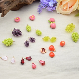 Detailed view of resin fruit charms like grape and peach for DIY jewelry making