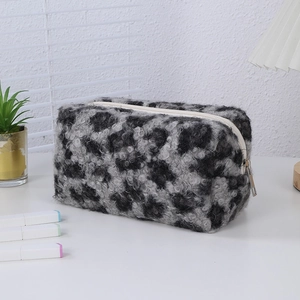 Close-up of leopard print plush makeup bag with soft texture and sturdy metal zipper