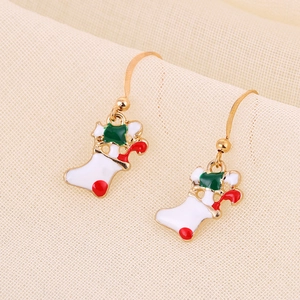 Close-up of Christmas stocking drop earrings in festive red, white and green enamel