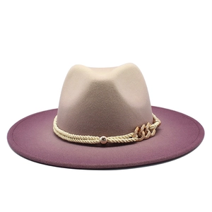 Detail of wool fedora featuring dual-tone gradient design and golden metallic chain band