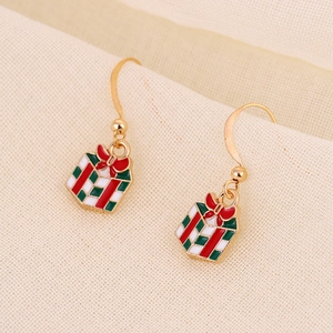 Detail of Christmas gift box earrings in red and green enamel with golden ear hooks