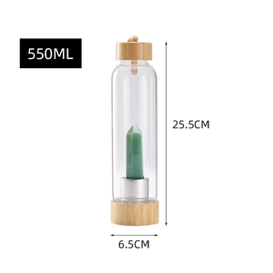 Detailed view of 550ml glass water bottle with bamboo lid and green crystal pillar inside