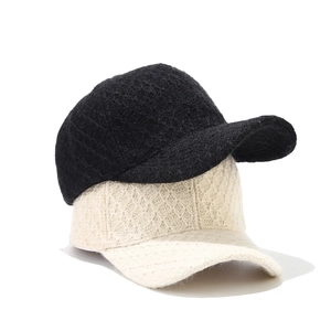 Winter knitted baseball caps in black and cream featuring premium textured fabric