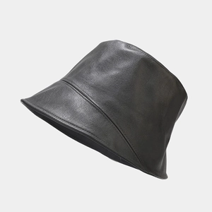 Detailed view of black PU leather bucket hat with precise stitching and minimalist texture
