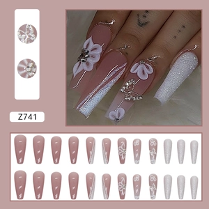 Detail view of pink ballerina press-on nails with 3D floral and rhinestone accents