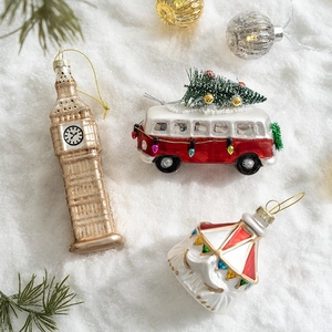 Festive Christmas glass ornaments featuring Big Ben, a red vintage bus, and retro figures