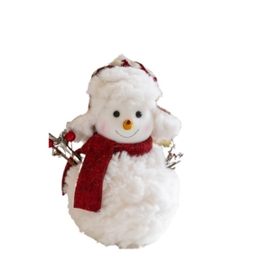 Plush Christmas snowman figurine with red scarf and plaid hat decoration on white background