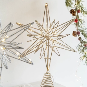 Golden iron Christmas tree topper star with warm LED lights and a spiral spring base