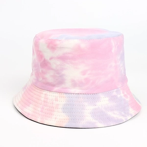 Close-up of vibrant pink and purple tie-dye patterns on cotton twill bucket hat fabric