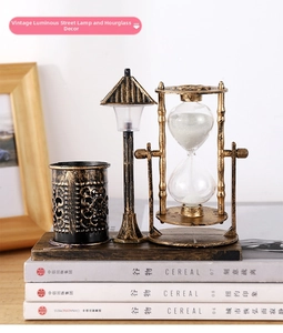 Macro shot of a vintage metal-textured pen holder with a rotating white sand hourglass