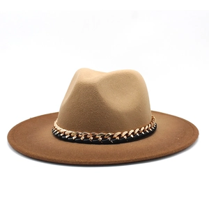 Detail of two-tone gradient fedora hat with camel crown, brown brim and gold chain